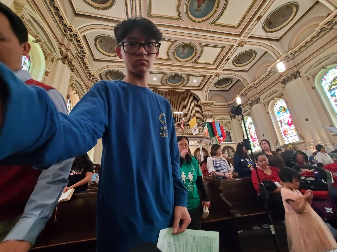 Aaron standing in an ornate church