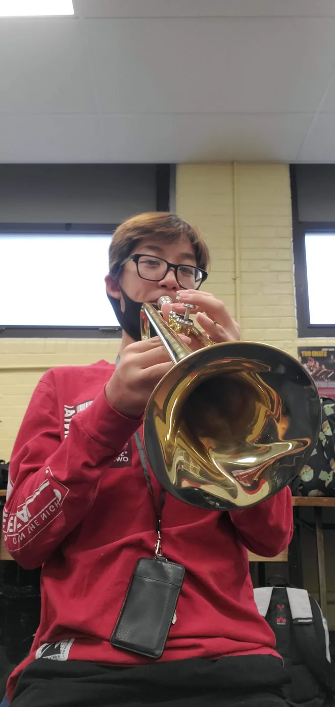Aaron playing trumpet in a rehearsal room
